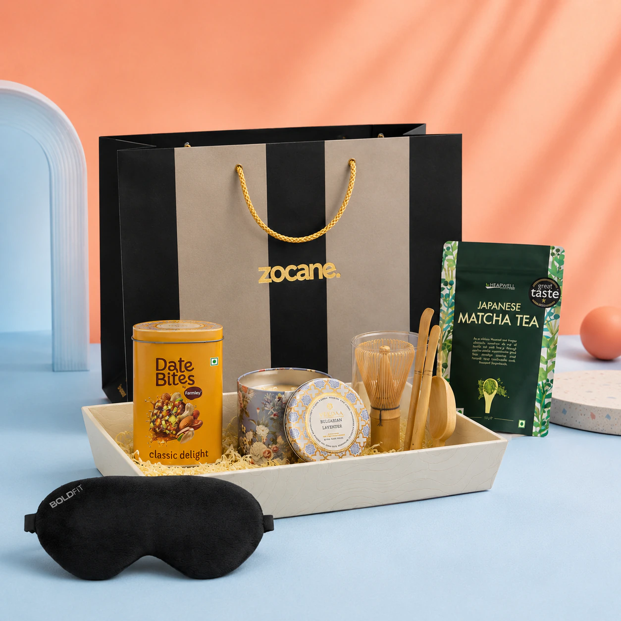 A matcha whisk, tea, date bites, candle, and note arranged as a calm morning gift
