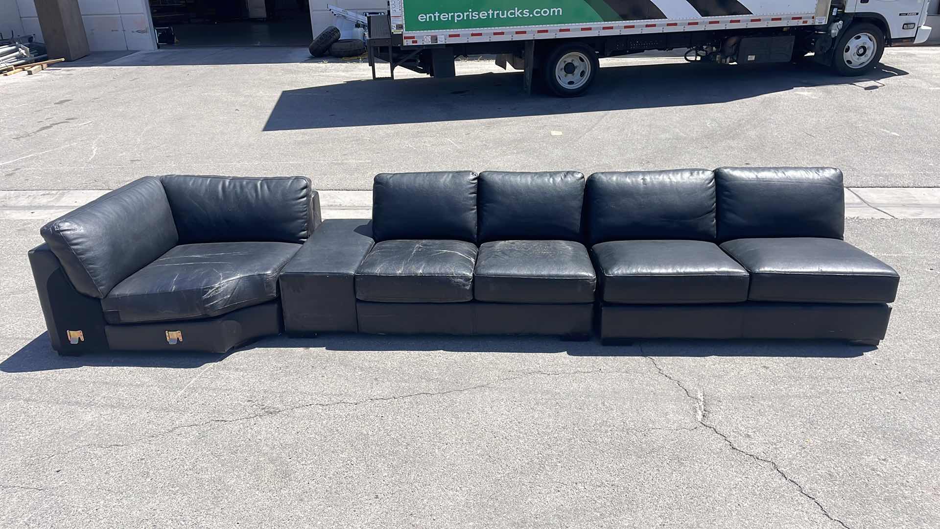 Photo 1 of BLACK LEATHER MULTI SECTION COUCH 165” x45”