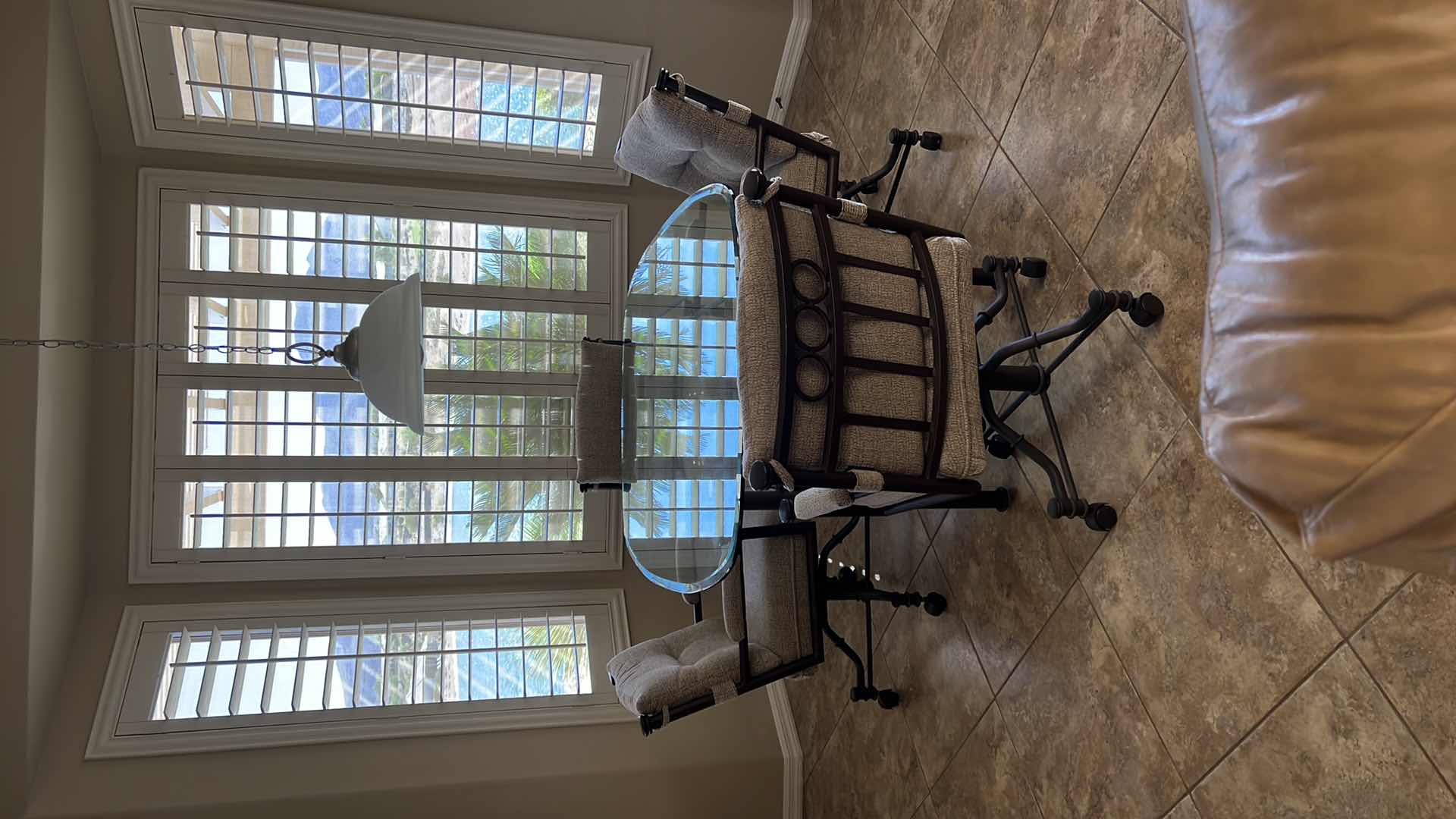 Photo 1 of WROUGHT IRON GLASSTOP TABLE W 4 WROUGHT IRON SWIVEL ROLLING CHAIRS (TABLE 50”x42” H30”)