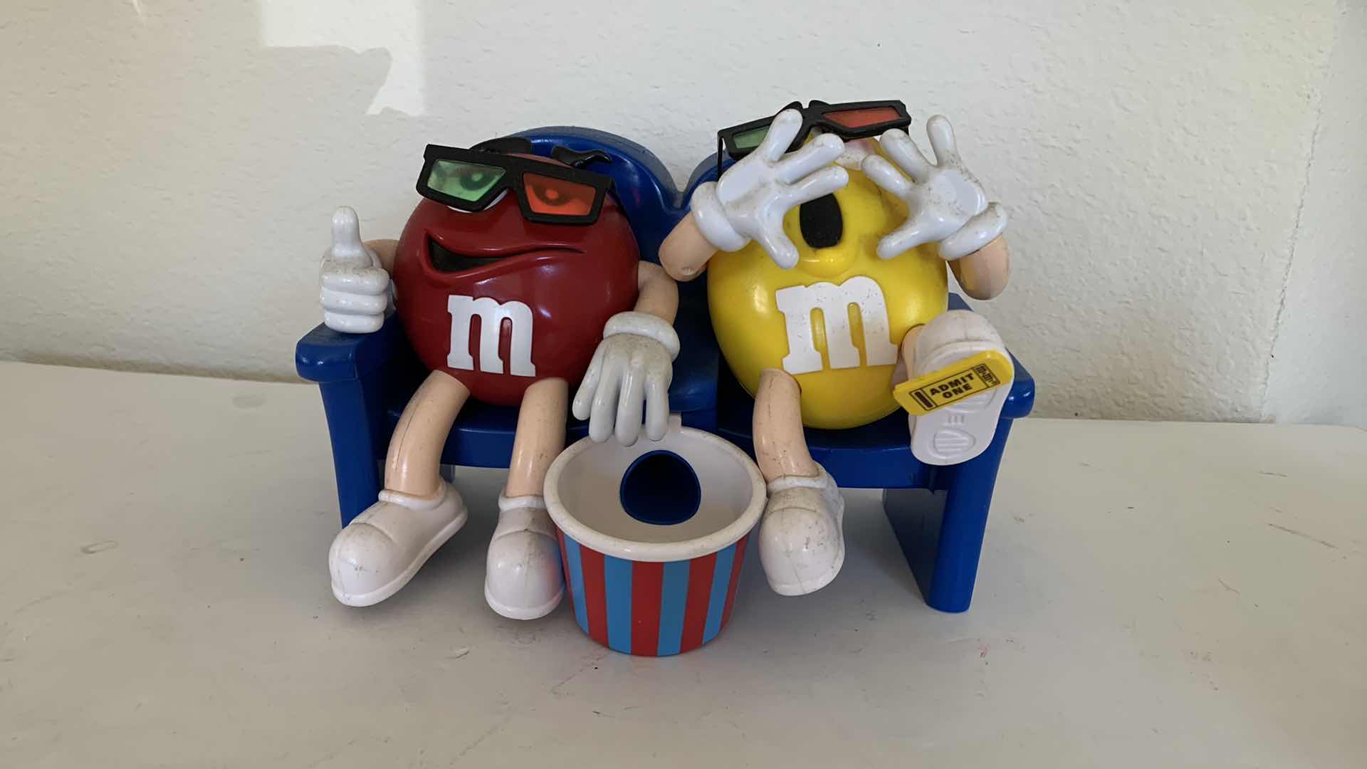 Photo 1 of M & Ms RED AND YELLOW 3D MOVIE CANDY DISPENSER COLLECTIBLE.