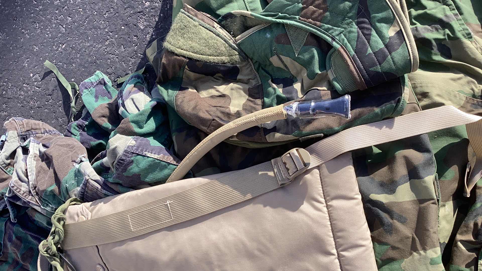 Photo 2 of DUFFLE BAG FULL OF CAMOUFLAGE GEAR AND WATER