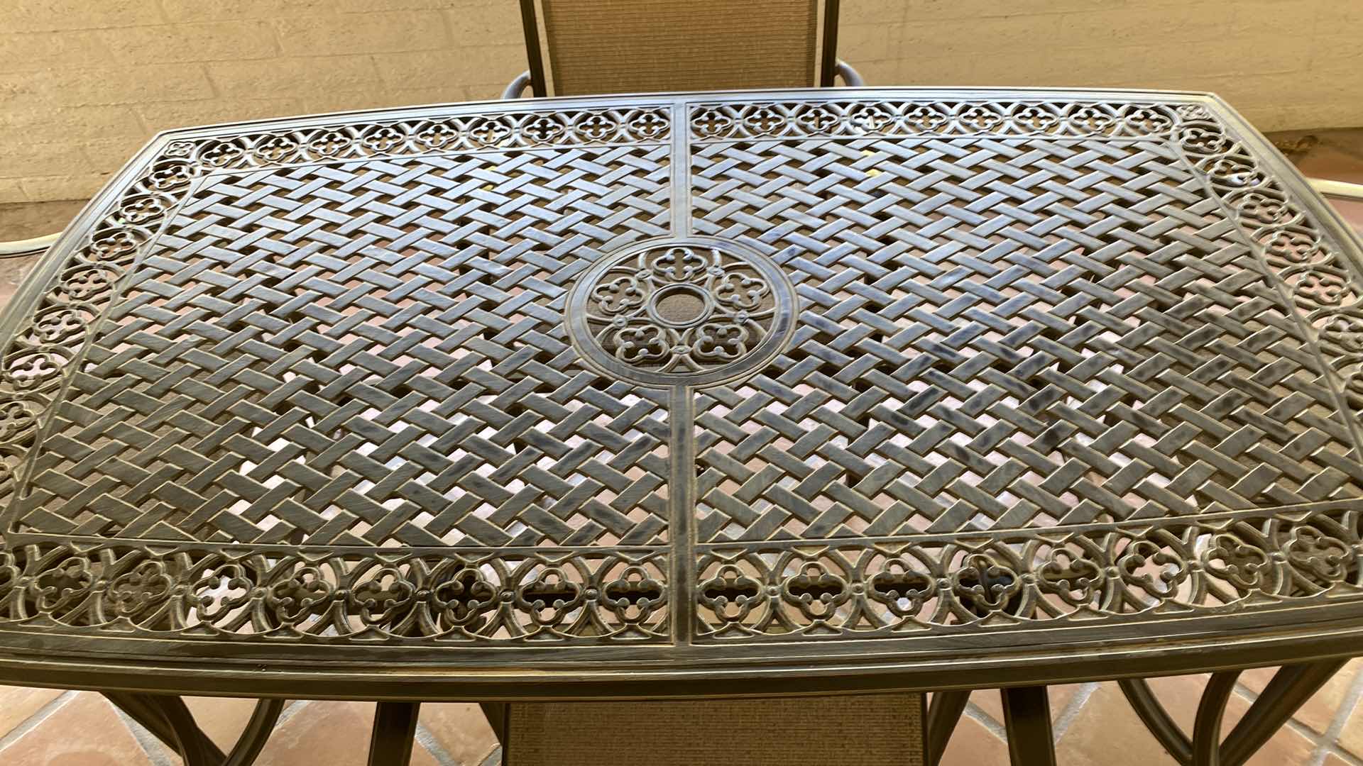 Photo 2 of ALUMINUM PATIO TABLE 67” X 38” H29” WITH 4 CHAIRS