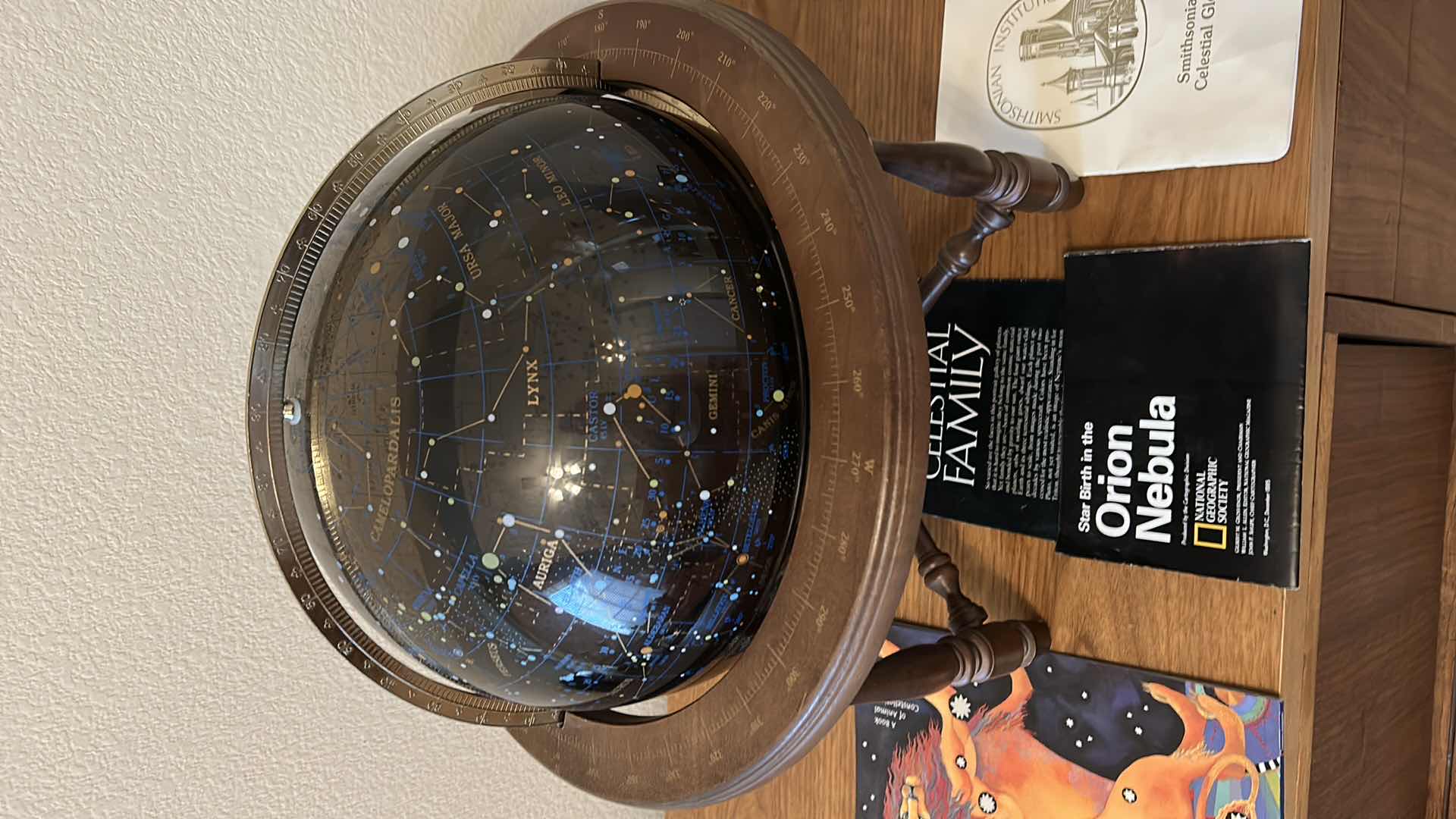 Photo 2 of Glass celestial globe with pamphlets and "Zoo in the sky' book  (globe with base measures 17” x 17”)