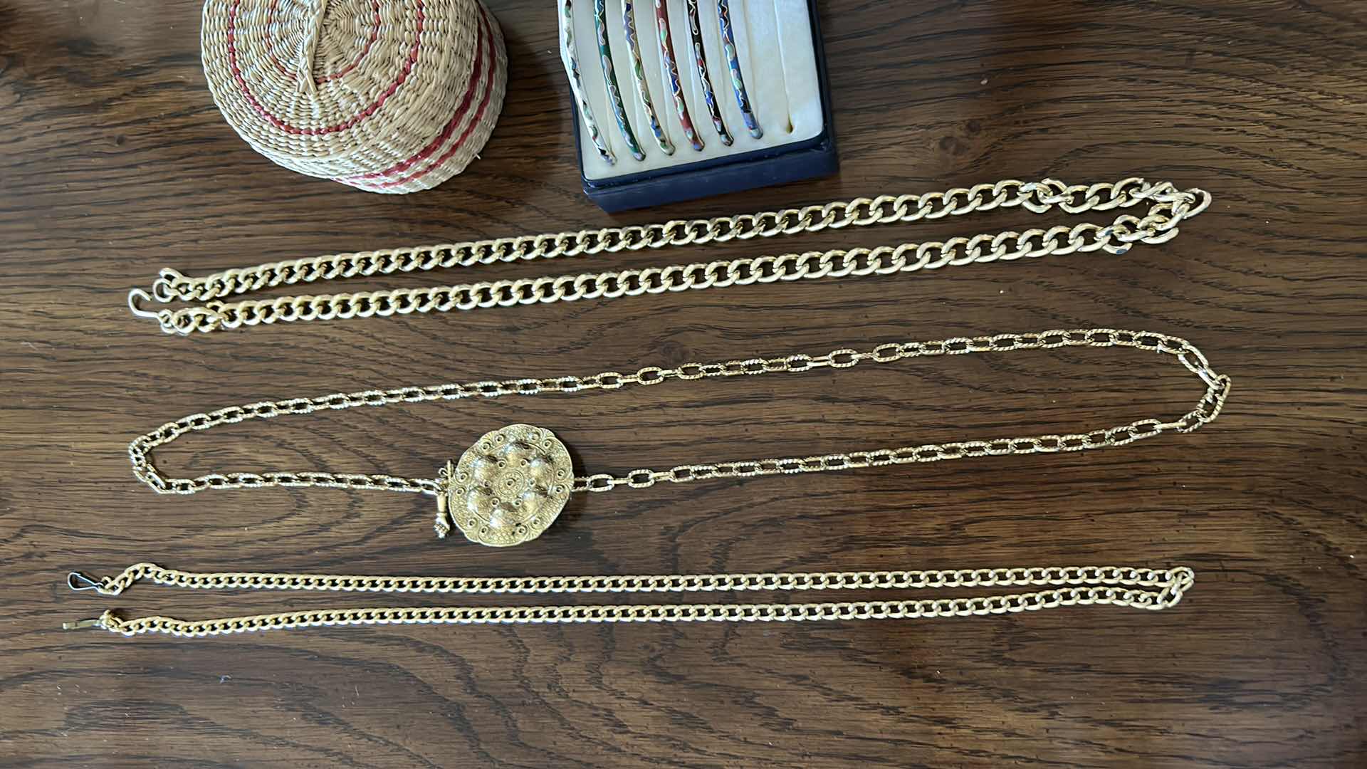Photo 3 of Three gold chain belts, a collection of bracelets and wicker basket