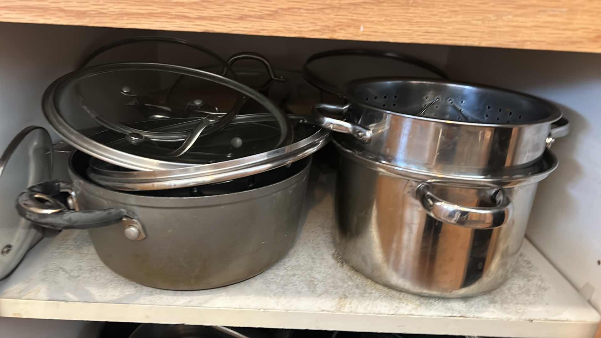 Photo 2 of CONTENTS OF KITCHEN CABINET-.POTS PANS AND MORE