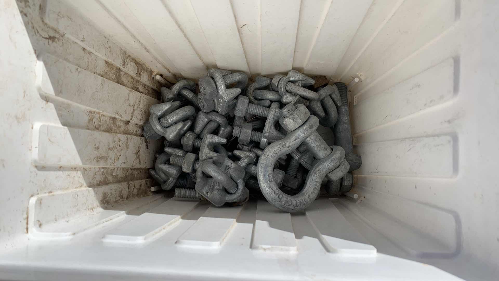 Photo 1 of BIN OF DIFFERENT SIZED GALVANIZED CABLE CLAMPS