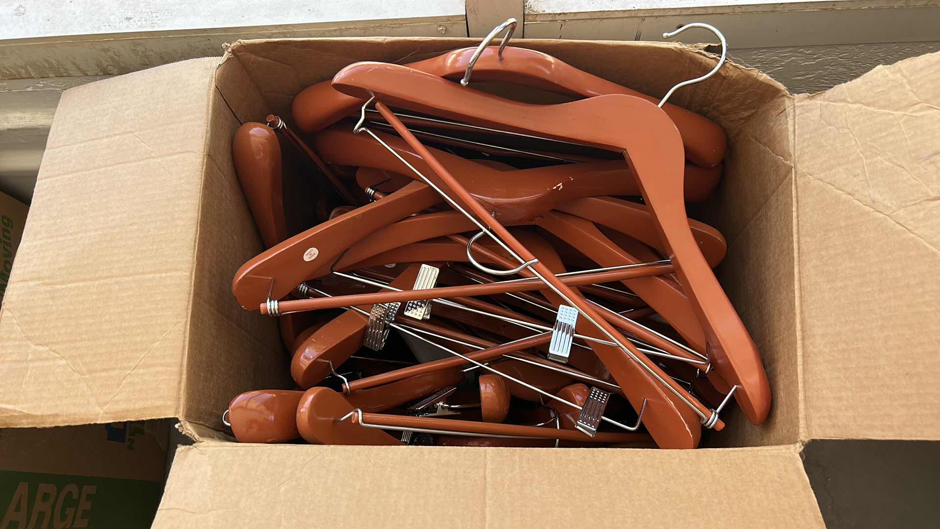 Photo 2 of LARGE BOX FULL OF WOOD HANGERS