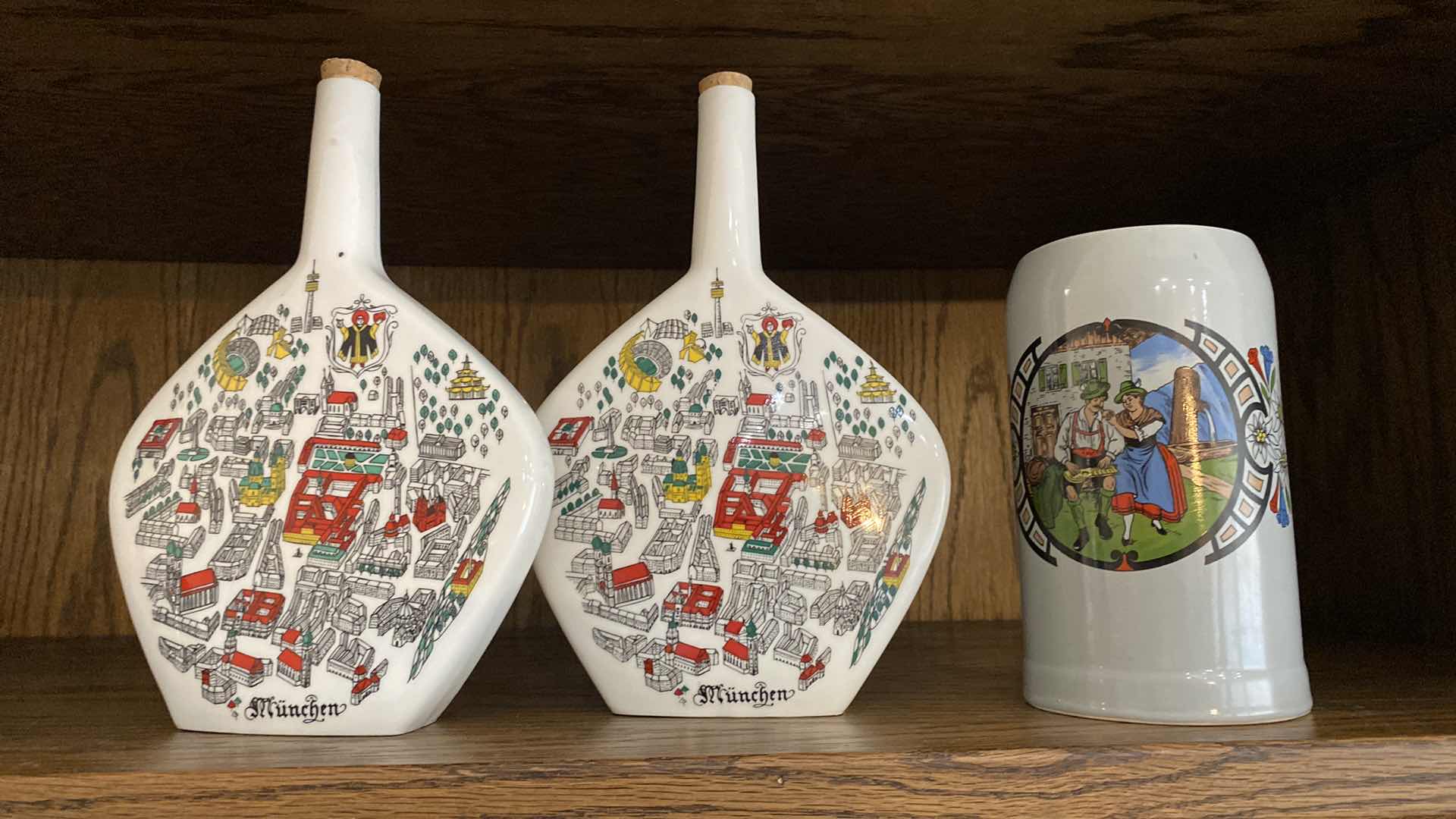 Photo 1 of PAIR OF MYNCHEN BOTTLES H10.5” FROM MUNICH AND MUG FROM EL PASO TX