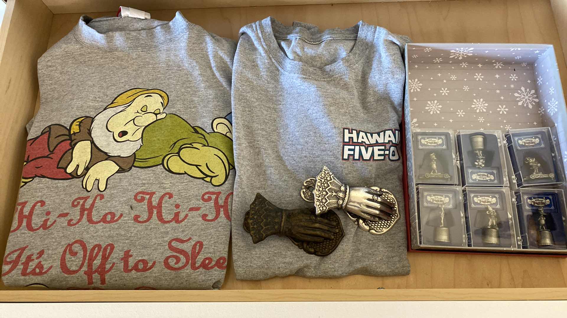 Photo 1 of CONTENTS OF DRAWER FAMILY ROOM DISNEY T SHIRT AND THIMBALS AND MORE