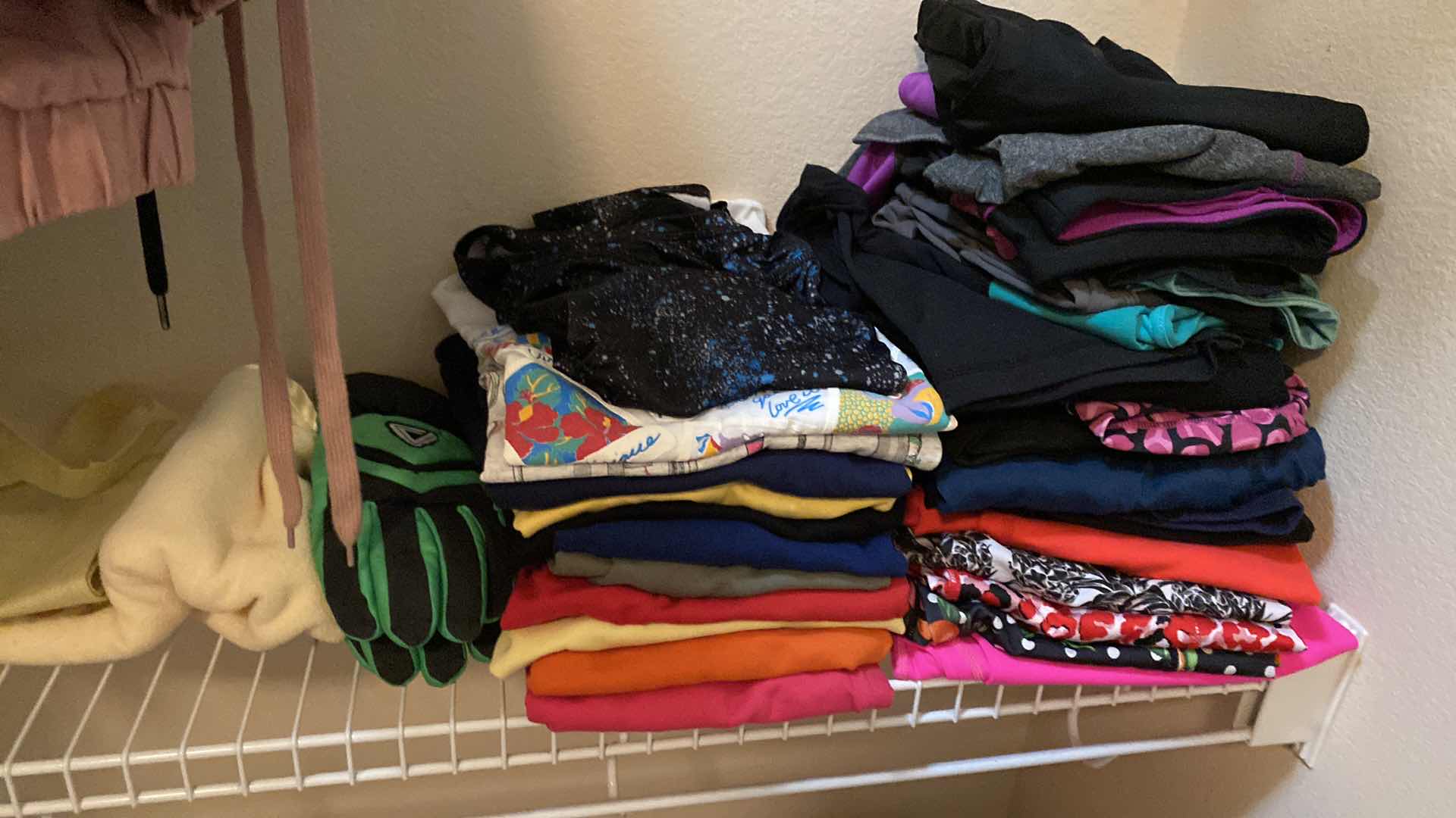 Photo 1 of WOMENS SIZE SMALL AND MEDIUM SHELF OF LEGGINGS AND SHIRTS