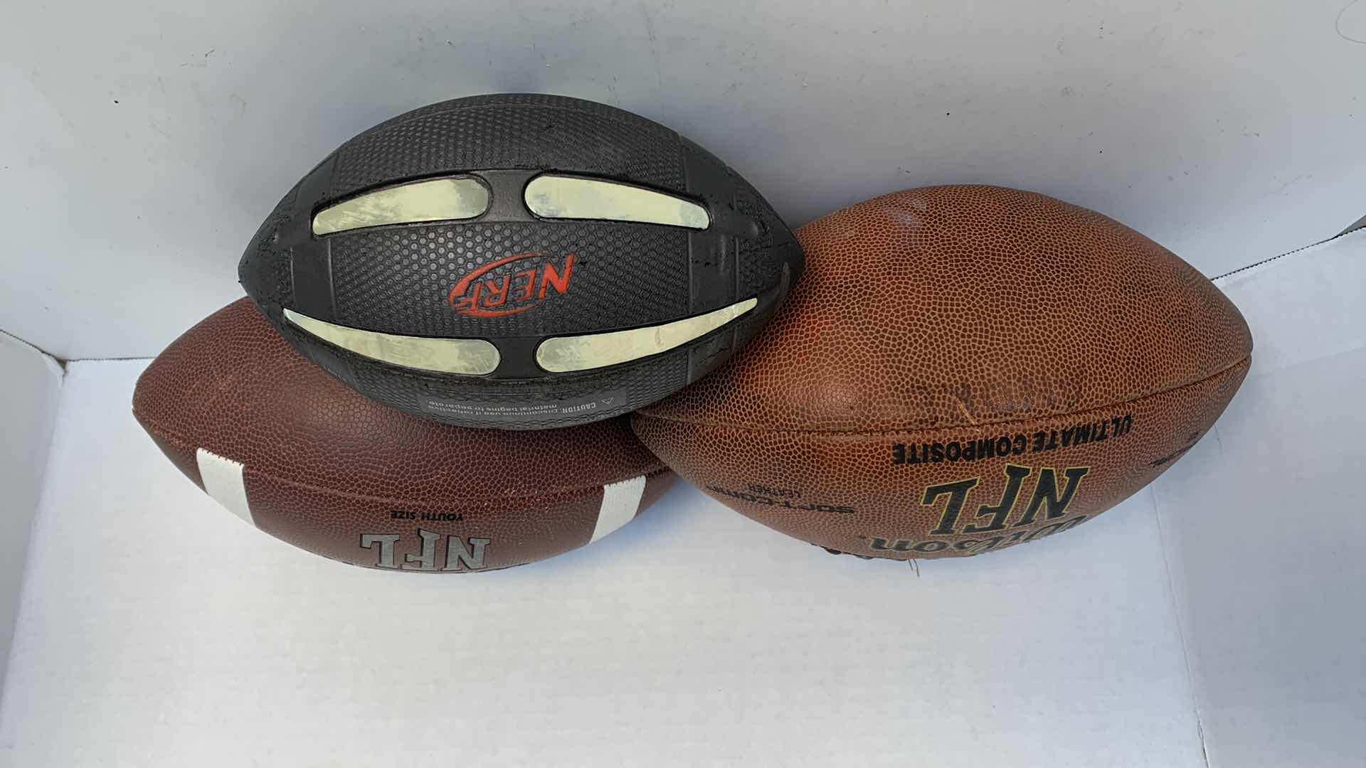 Photo 1 of WILSON NFL FOOTBALLS AND NERF FOOTBALL