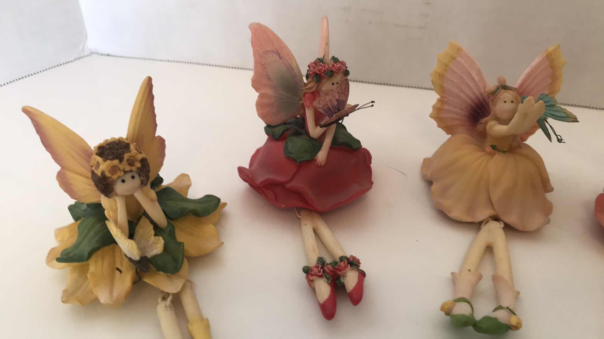 Photo 2 of COLLECTION OF SIX CERAMIC FAIRIES WITH DANGLING LEGS, APPROX 4” SITTING