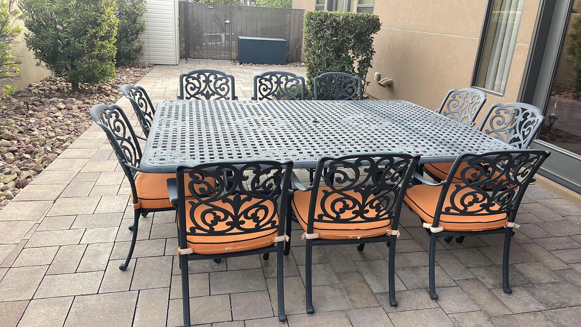 Photo 1 of LUXURY PATIO FURNITURE SET - TABLE 64” X 90” WITH 10 CHAIRS ORANGE CUSHIONS WITH BLACK WELTING