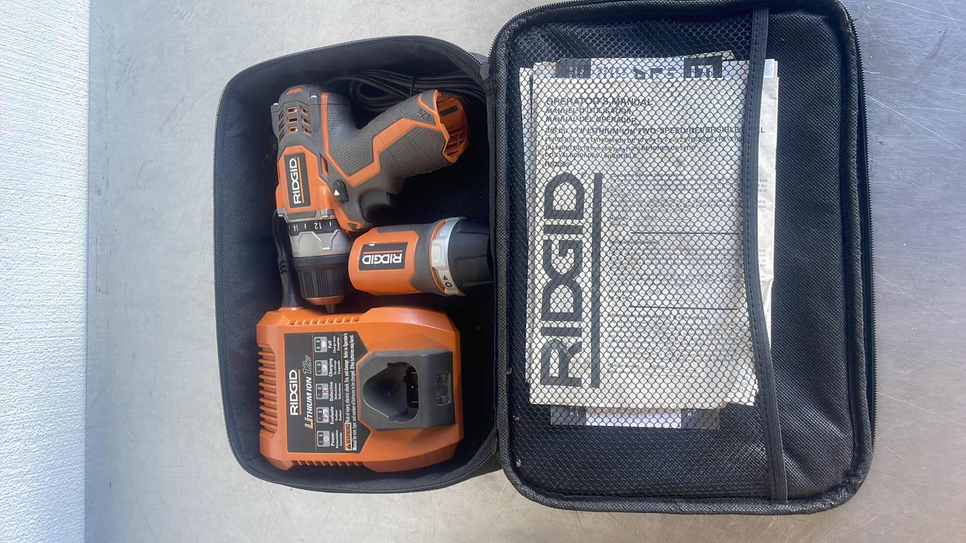 Photo 1 of RIDGID 12V WORKLIGHT R82920 & 3/8” 12V DRILL R82009 WITH CHARGER IN SOFT CASE NO BATTERY UNTESTED