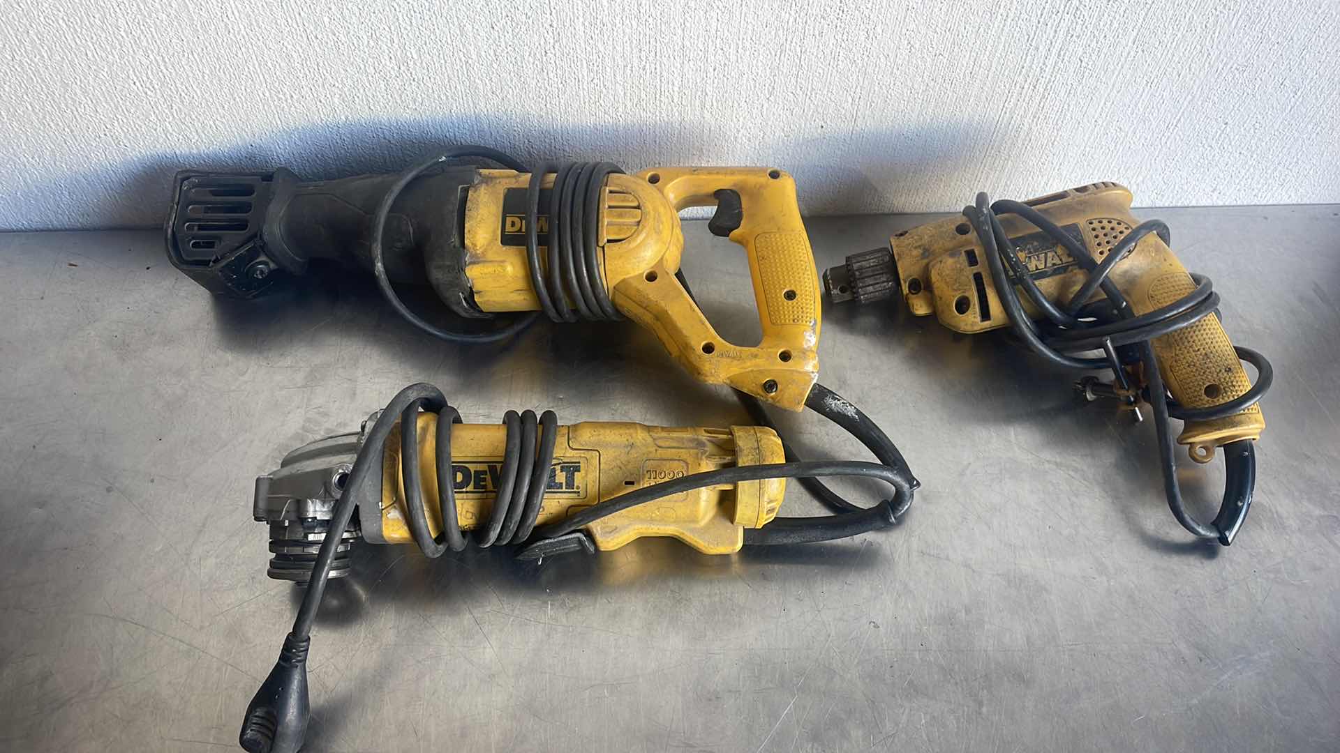 Photo 1 of DEWALT RECIPROCATING SAW 4 1/2” ANGLE GRINDER AND 3/8” DRILL