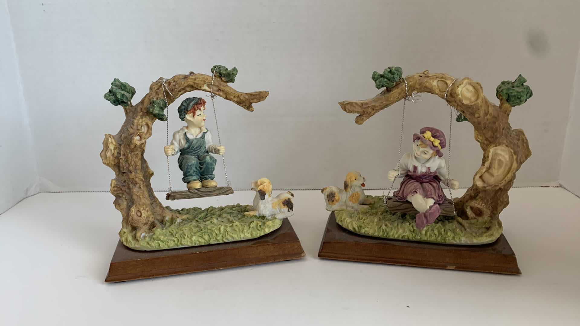 Photo 1 of SET OF 2 DAVINCI COLLECTION CHILDREN ON SWINGS STATUES