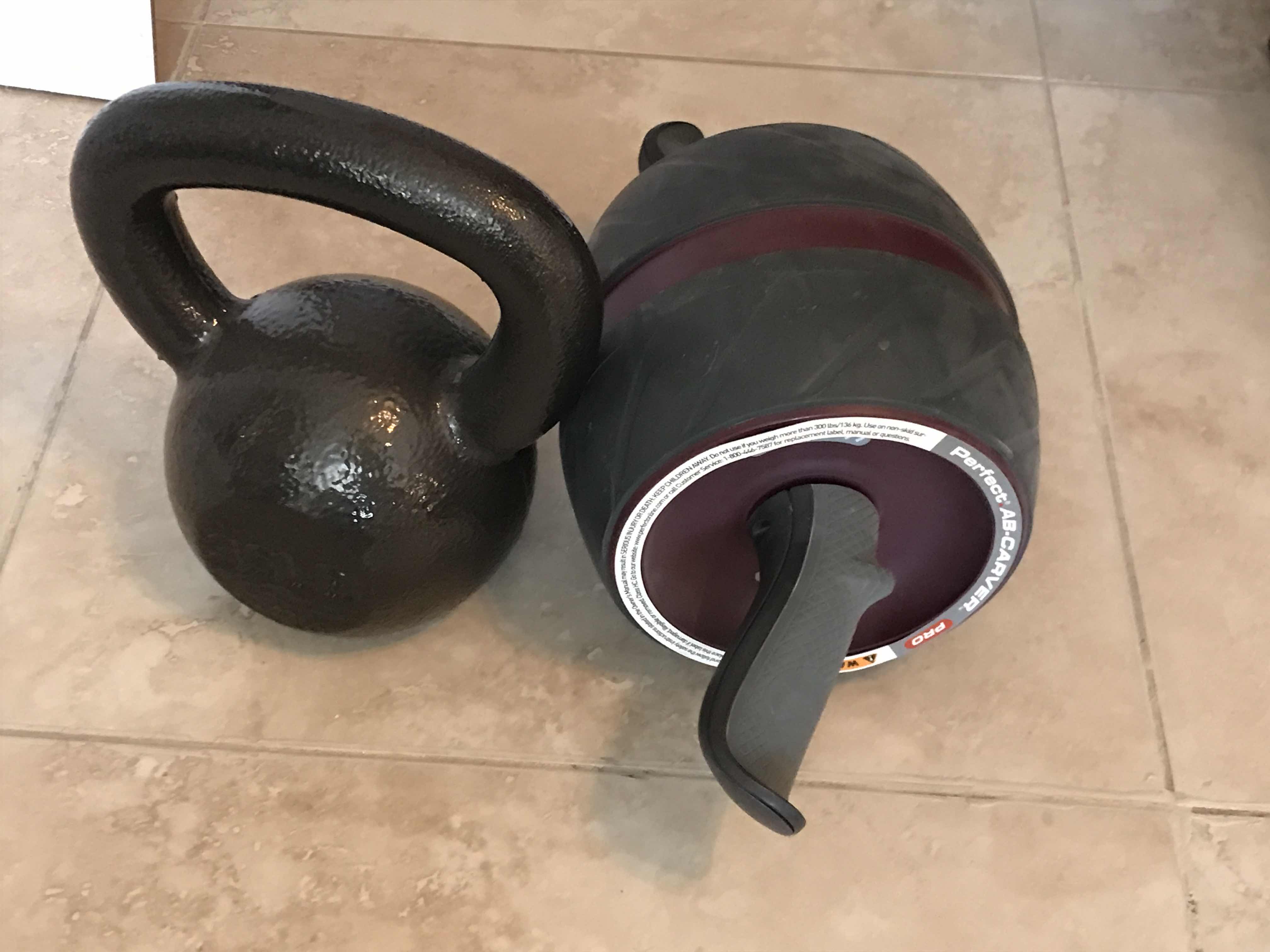 Photo 1 of GYM EQUIPMENT KETTLE BALL AND AB ROLLER