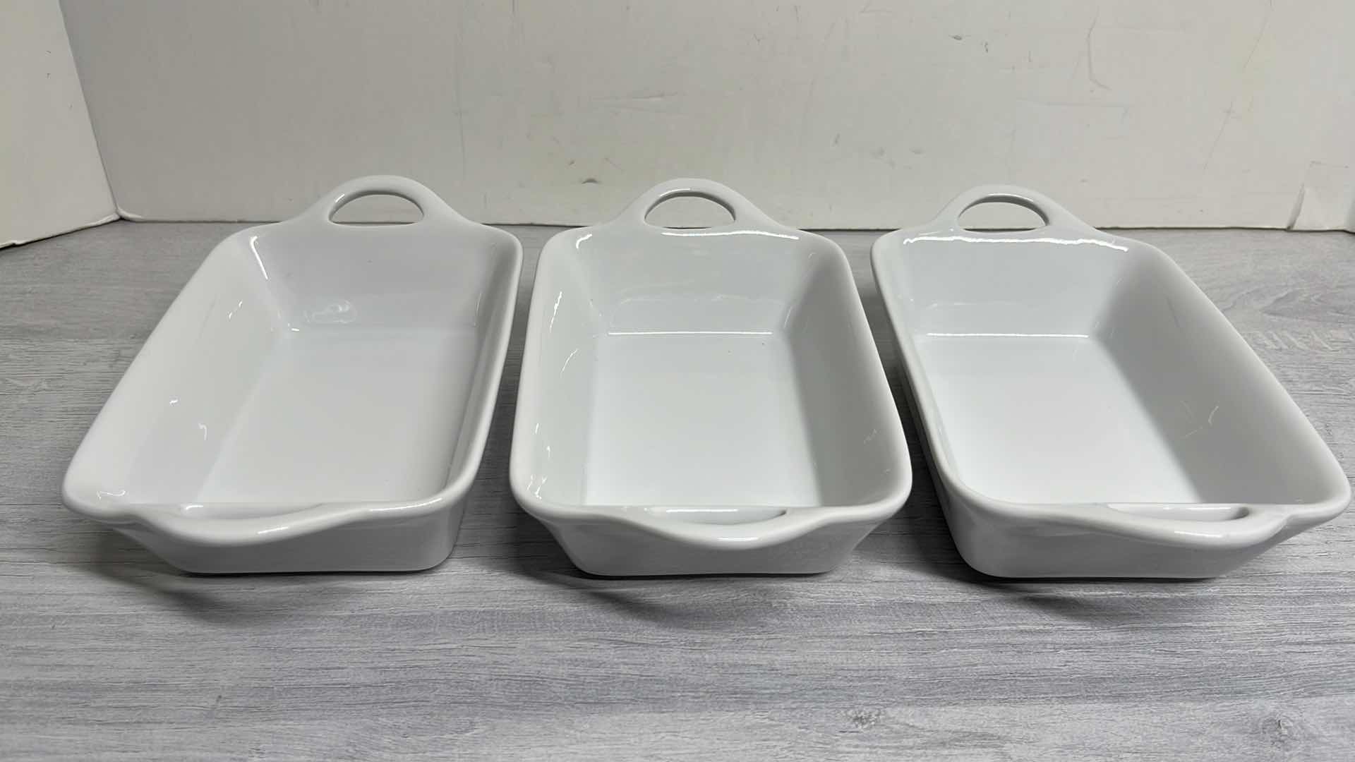 Photo 2 of SUR LA TABLE .5 QT RECTANGULAR BAKERS 4.5” X 6.25” H2” (3) & 8 oz COCETTE ROUND BAKING DISH W LID 5.5” X 3” (1)