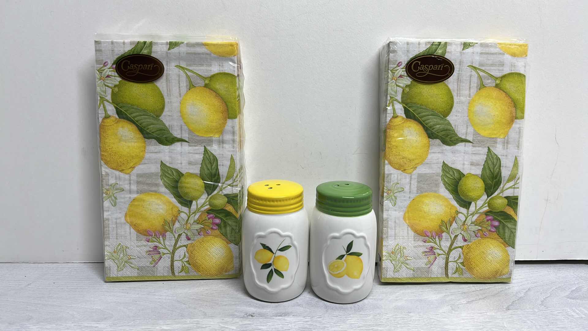 Photo 1 of LEMON DECOR SALT & PEPPER SHAKERS & 2 PACKS OF CASPARI CITRON 3-PLY NAPKINS (15 CT PER PACK)