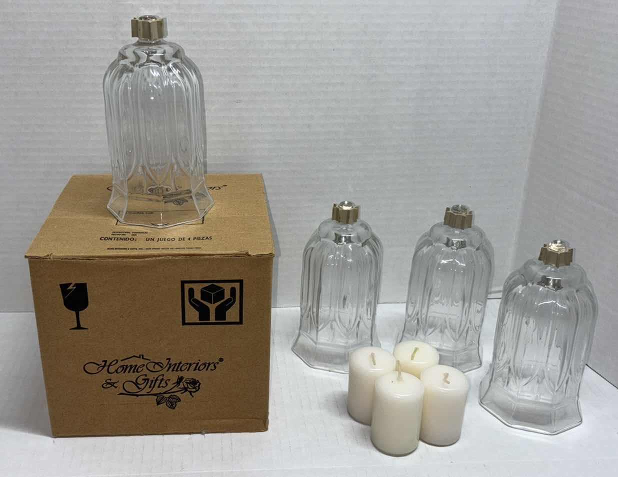 Photo 1 of CLEAR GLASS 5.5” PEG OCTAGON VOTIVE CUPS W CANDLES (4)