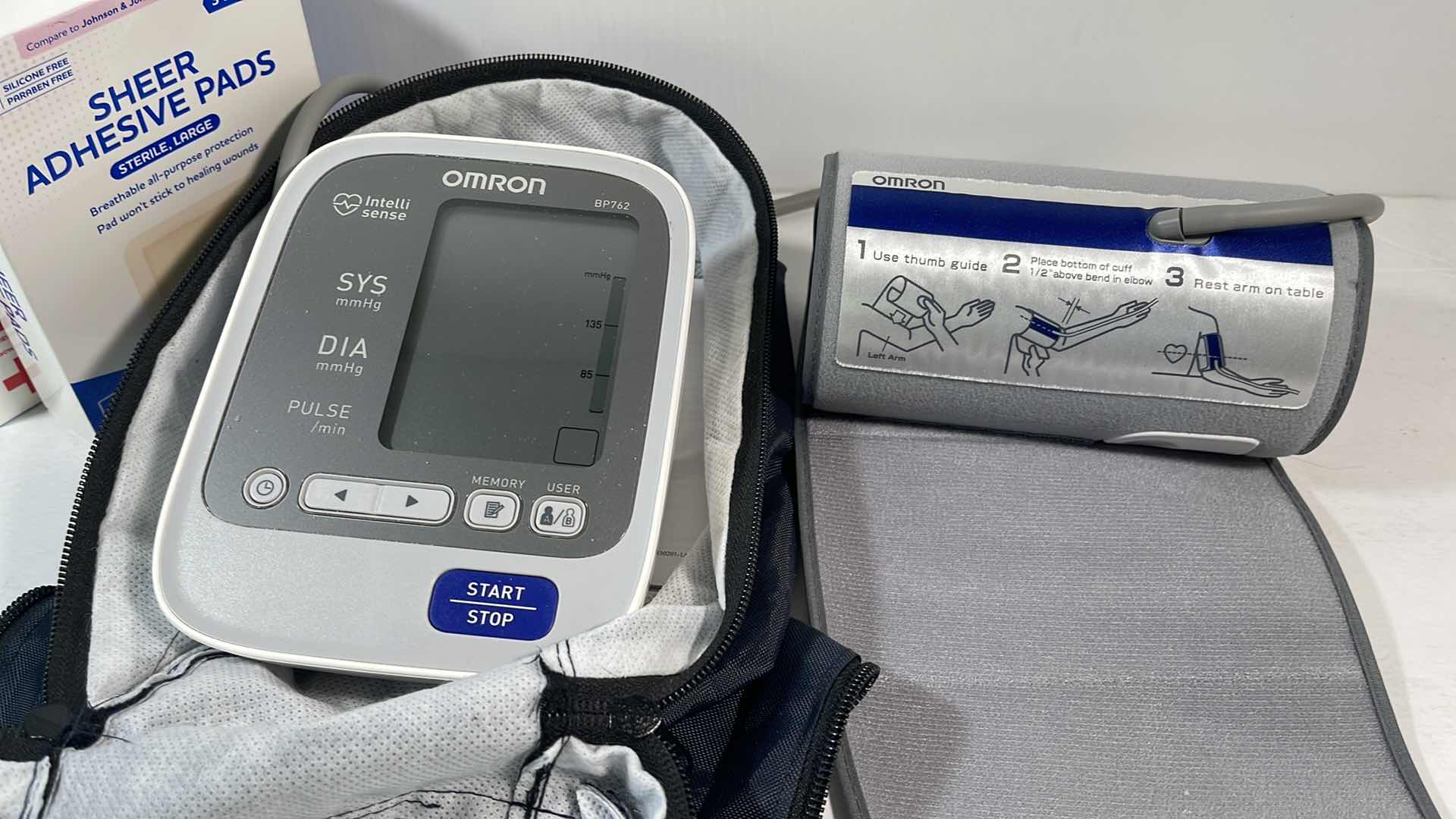 Photo 2 of OMRON BLOOD PRESSURE MONITOR MODEL BP762 & TWO BOXES OF BAND-AID