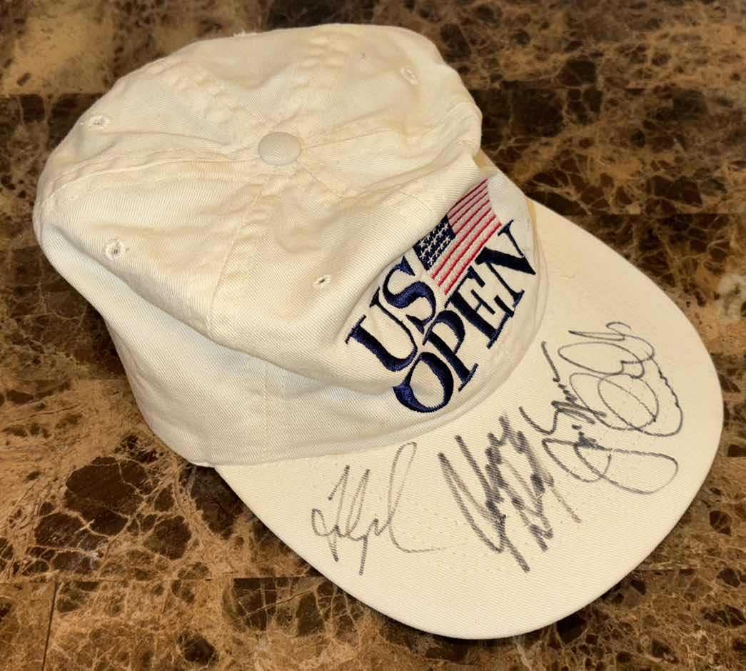 Photo 1 of GOLF ACCESSORIES- BALLS, TEES, BANKS, GAME & SIGNED HAT