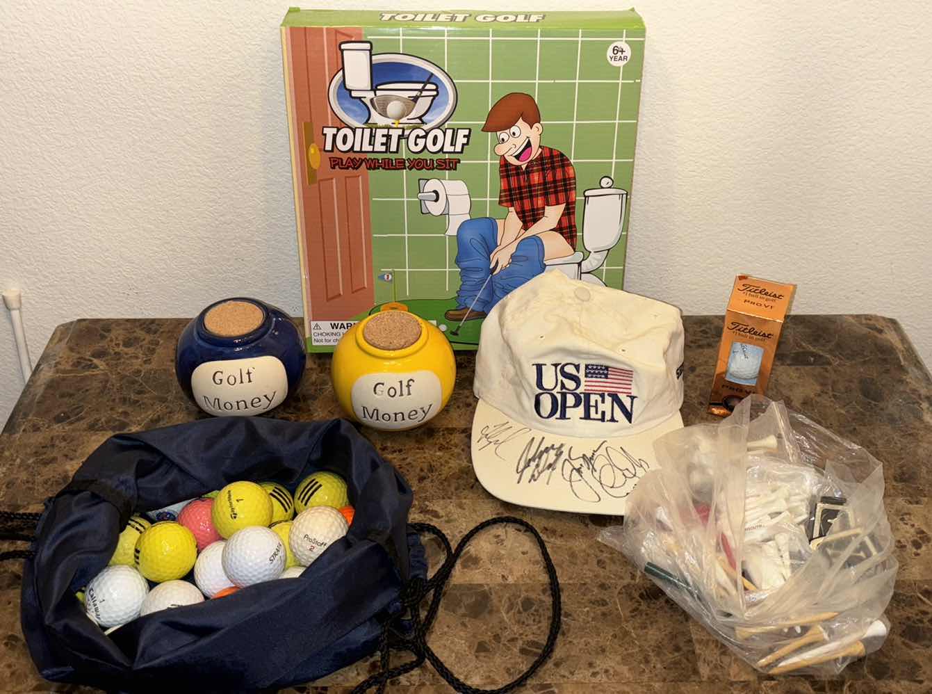 Photo 1 of GOLF ACCESSORIES- BALLS, TEES, BANKS, GAME & SIGNED HAT