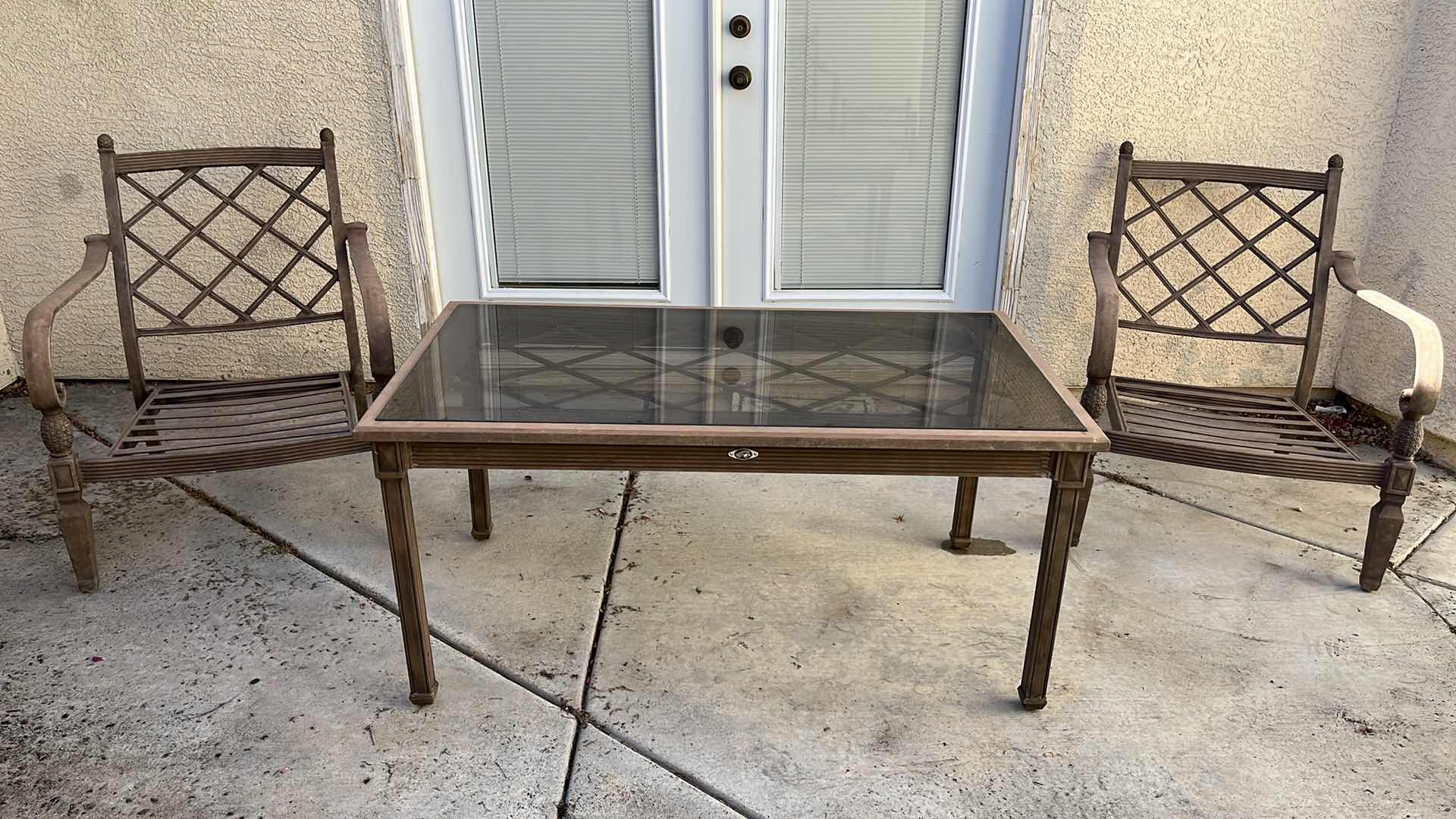Photo 1 of HAMPTON BAY PATIO GLASS TOP METAL FRAME TABLE 50” X 28” H23.75” W 2 OVERSIZED METAL FRAME PATIO CHAIRS 28” X 36” H34”