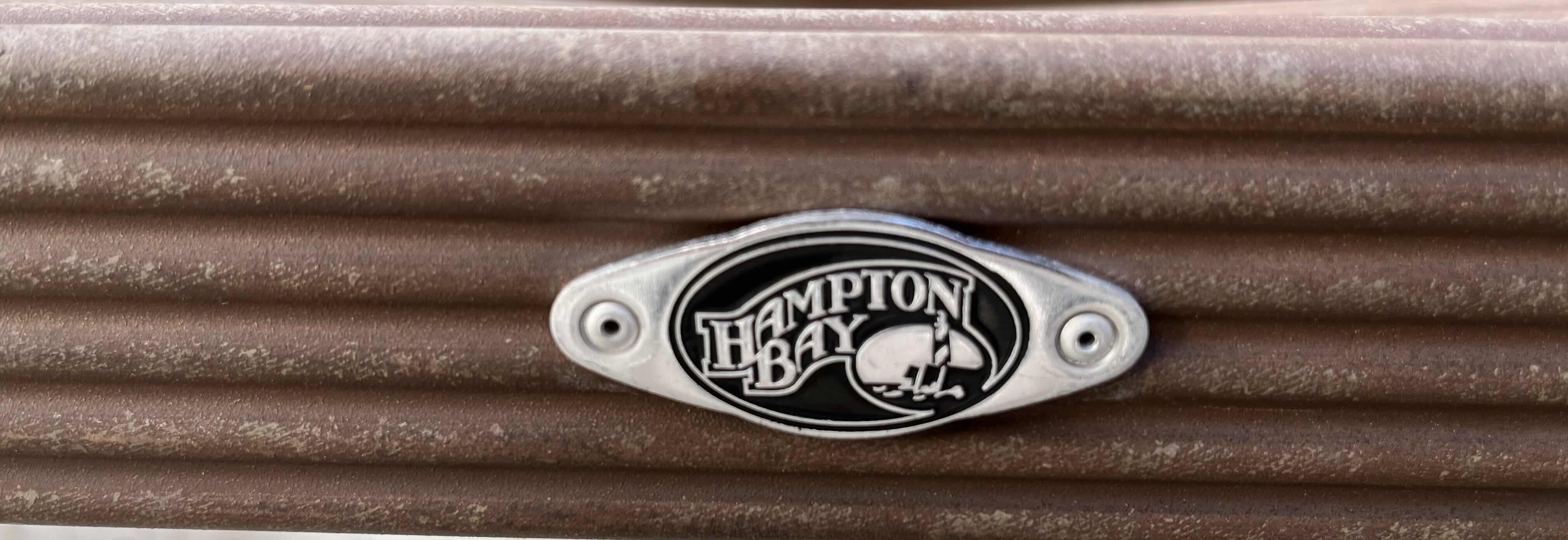 Photo 1 of HAMPTON BAY PATIO GLASS TOP METAL FRAME TABLE 50” X 28” H23.75” W 2 OVERSIZED METAL FRAME PATIO CHAIRS 28” X 36” H34”