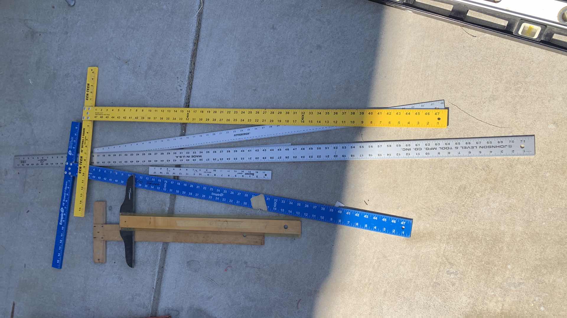 Photo 1 of ASSORTED DRYWALL T SQUARES AND METAL RULERS