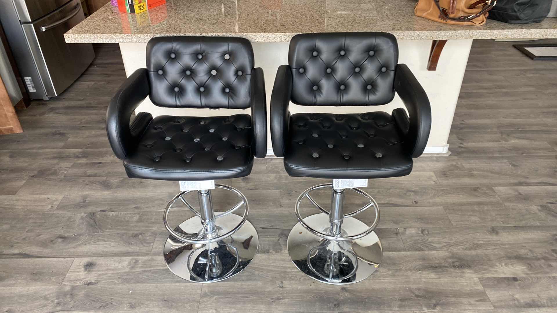 Photo 1 of PAIR OF BLACK BONDED LEATHER ADJUSTABLE BAR STOOLS LOEEST SEAT HEIGHT 24”