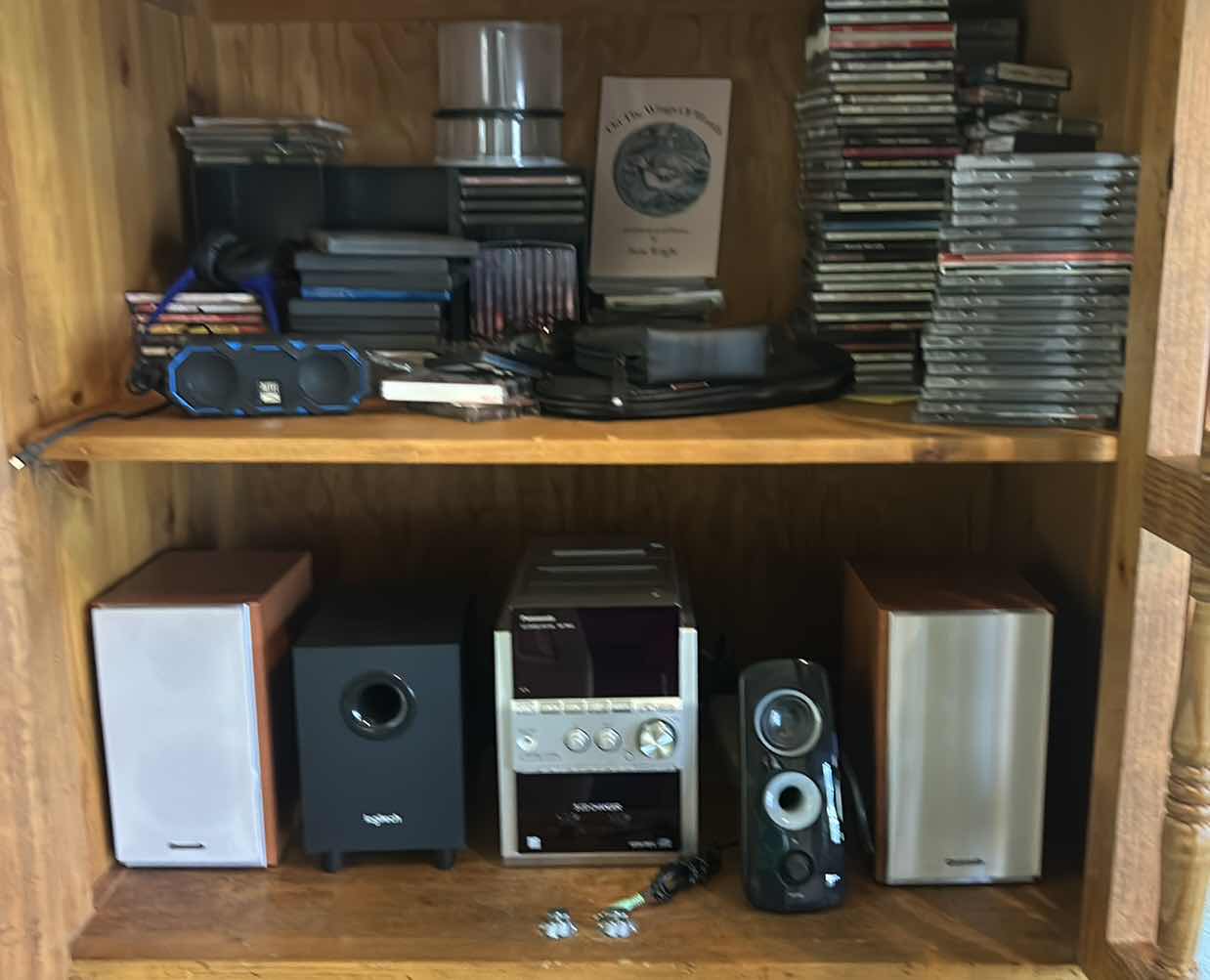 Photo 1 of CONTENTS OF ENTERTAINMENT CABINET: SPEAKERS, WOOFER, CD’s AND MORE