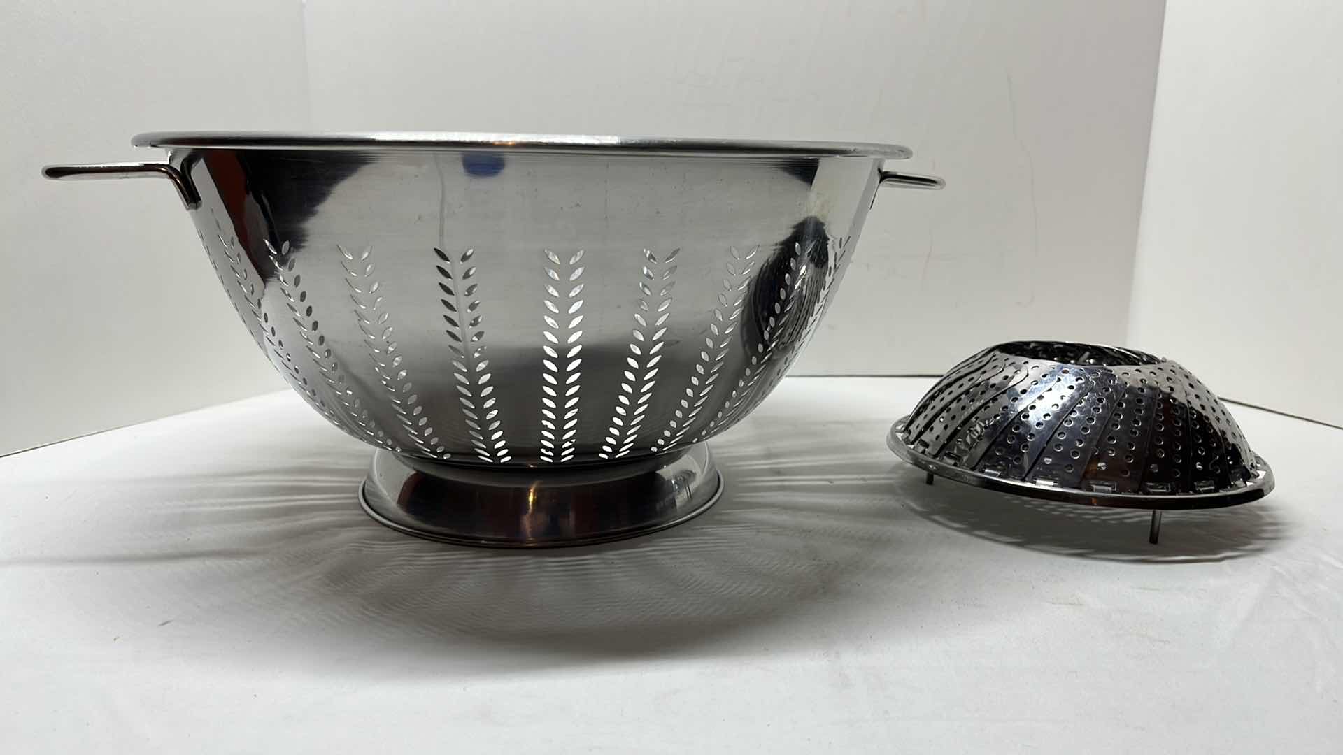 Photo 1 of STAINLESS STEEL COLANDER W HANDLES 13” X 6.75”H & STAINLESS STEEL STEAMER BASKET 6”