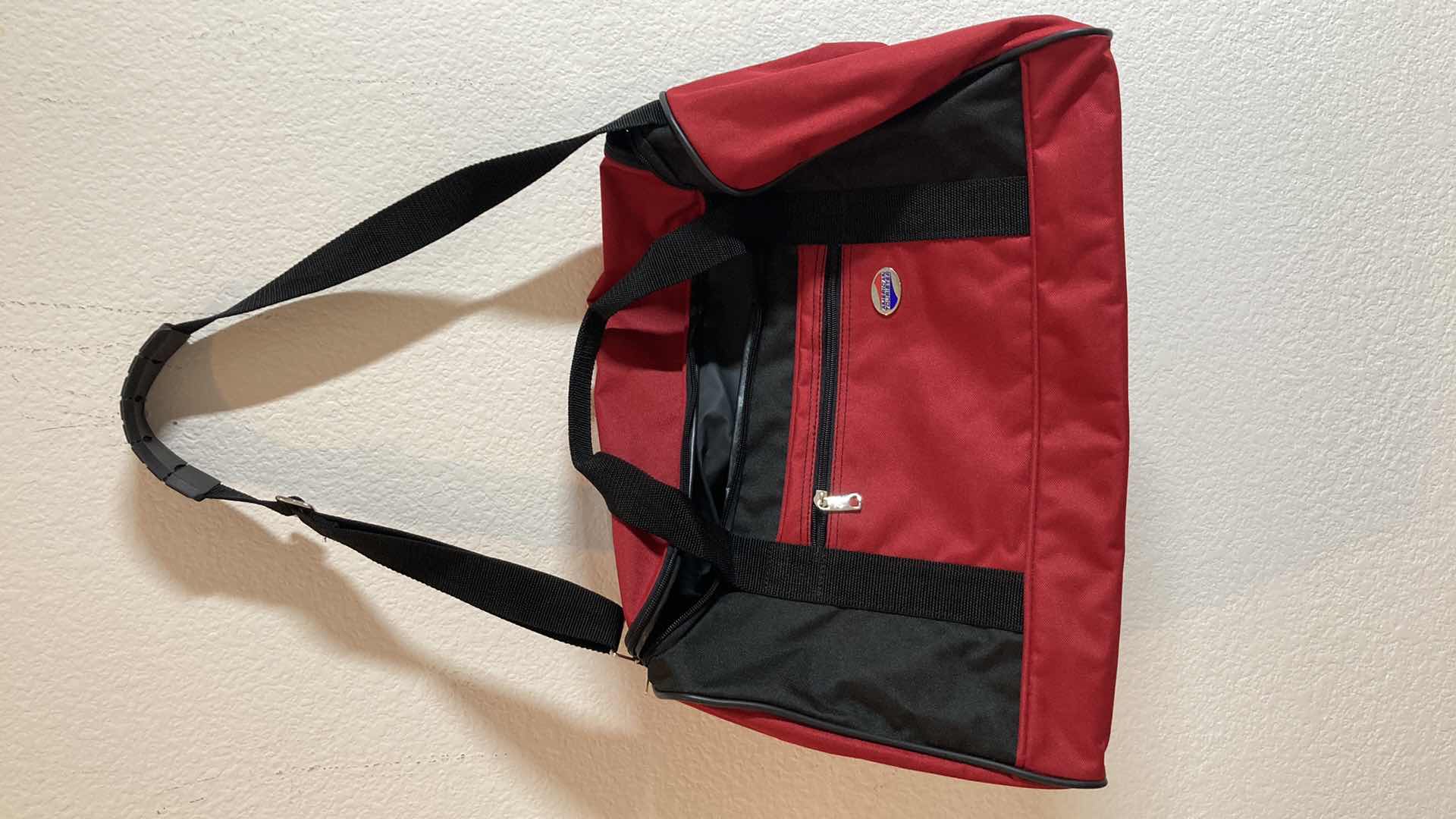 Photo 1 of AMERICAN TOURISTER RED DUFFEL BAG