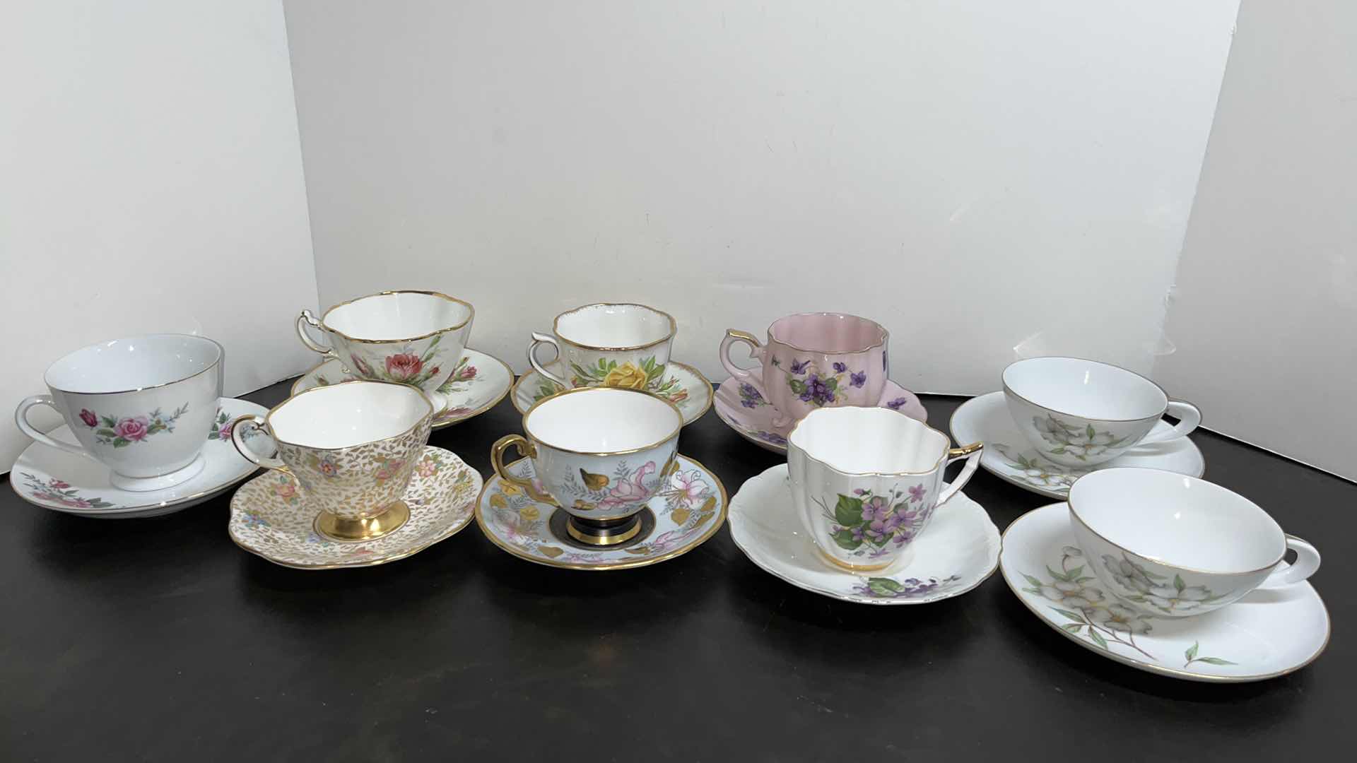 Photo 1 of ECLECTIC BONE & FINE CHINA 9 TEA CUPS/SAUCERS (18 PCS)