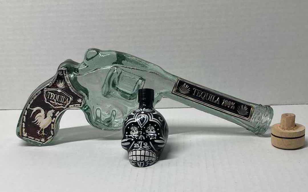 Photo 1 of LOS CABOS GLASS REVOLVER LIQUOR BOTTLE & KAH GLASS SKULL LIQUOR BOTTLE