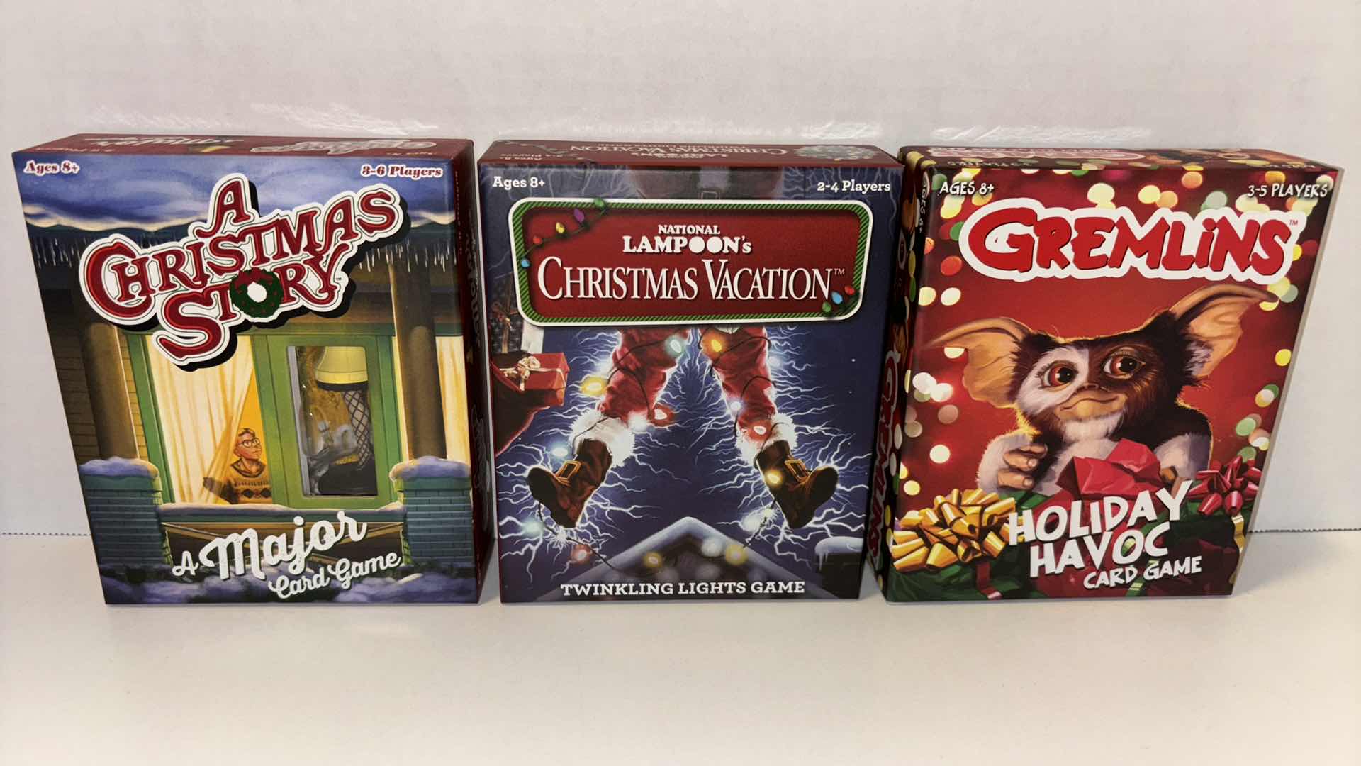 Photo 1 of FUNKO CARD GAMES, A CHRISTMAS STORY A MAJOR CARD GAME, NATIONAL LAMPOONS CHRISTMAS VACATION TWINKLING LIGHTS GAME, GREMLINS HOLIDAY HAVOC CARD GAME (3)