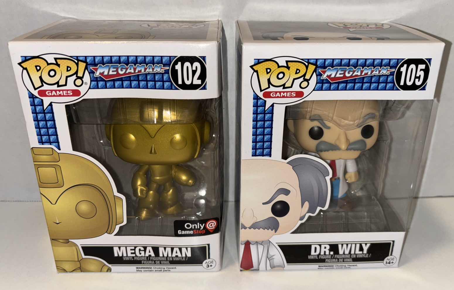 Photo 1 of NEW FUNKO POP! GAMES VINYL FIGURE, MEGAMAN 2-PACK GAMESTOP EXCLUSIVE #102 GOLD MEGA MAN ($75) & #105 DR. WILY ($12)