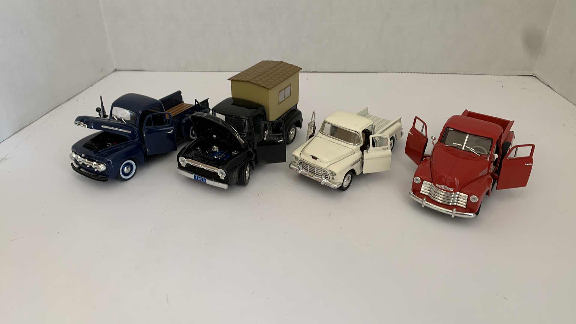 Photo 1 of SET OF 4 DIE CAST METAL FORD AND CHEVORLET TRUCKS 6” X 2” H 3”