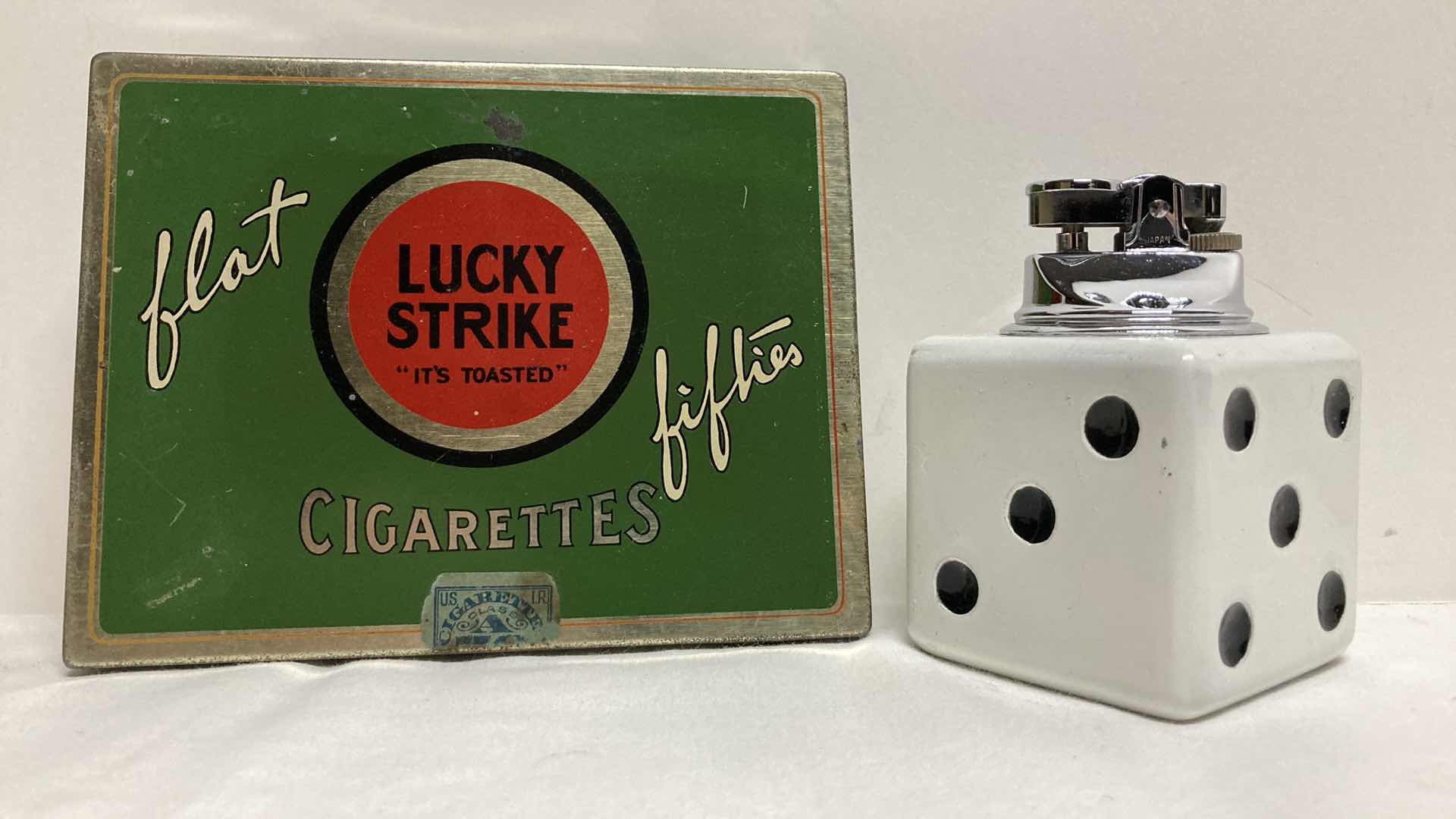 Photo 1 of LUCKY STRIKES FLAT FIFTIES TIN W DICE TABLE LIGHTER