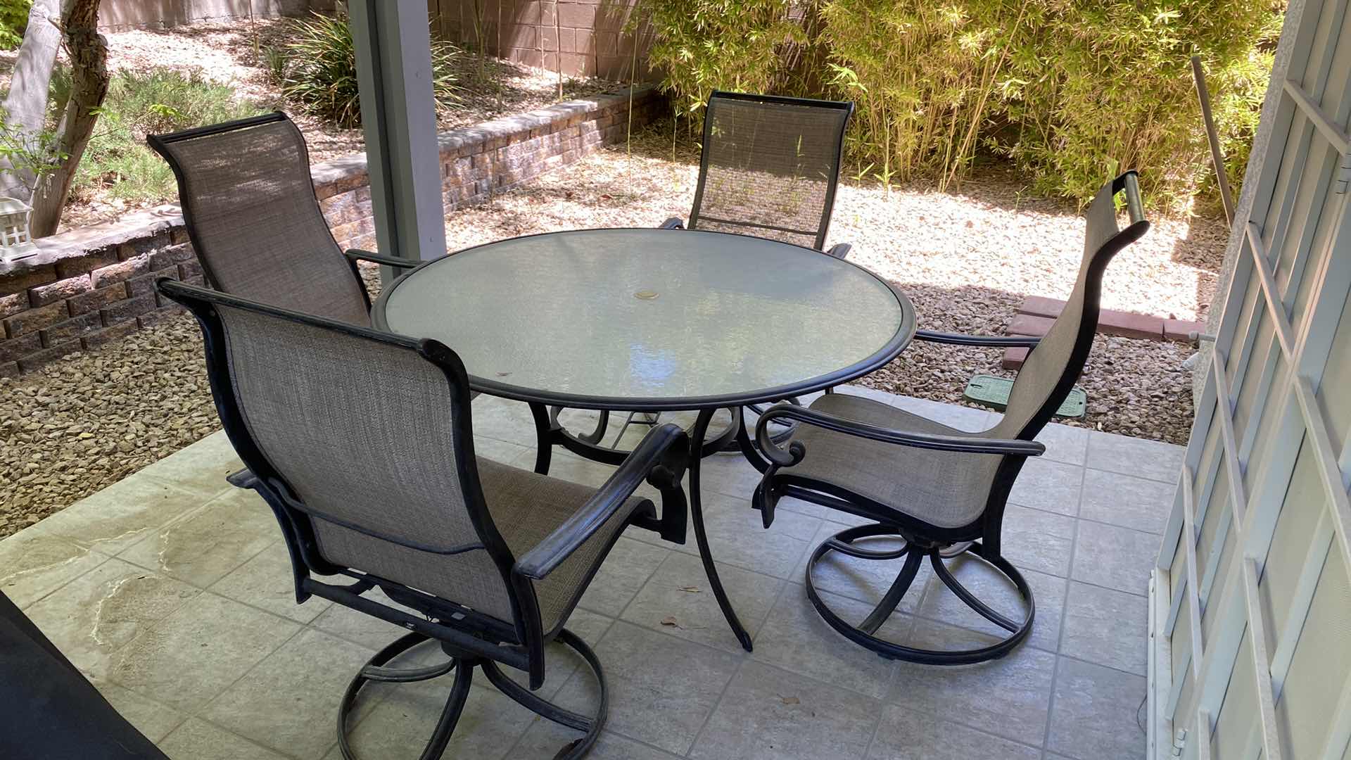 Photo 1 of GLASS AND ALUMINUM PATIO TABLE 54” WITH 4 SWIVEL CHAIRS