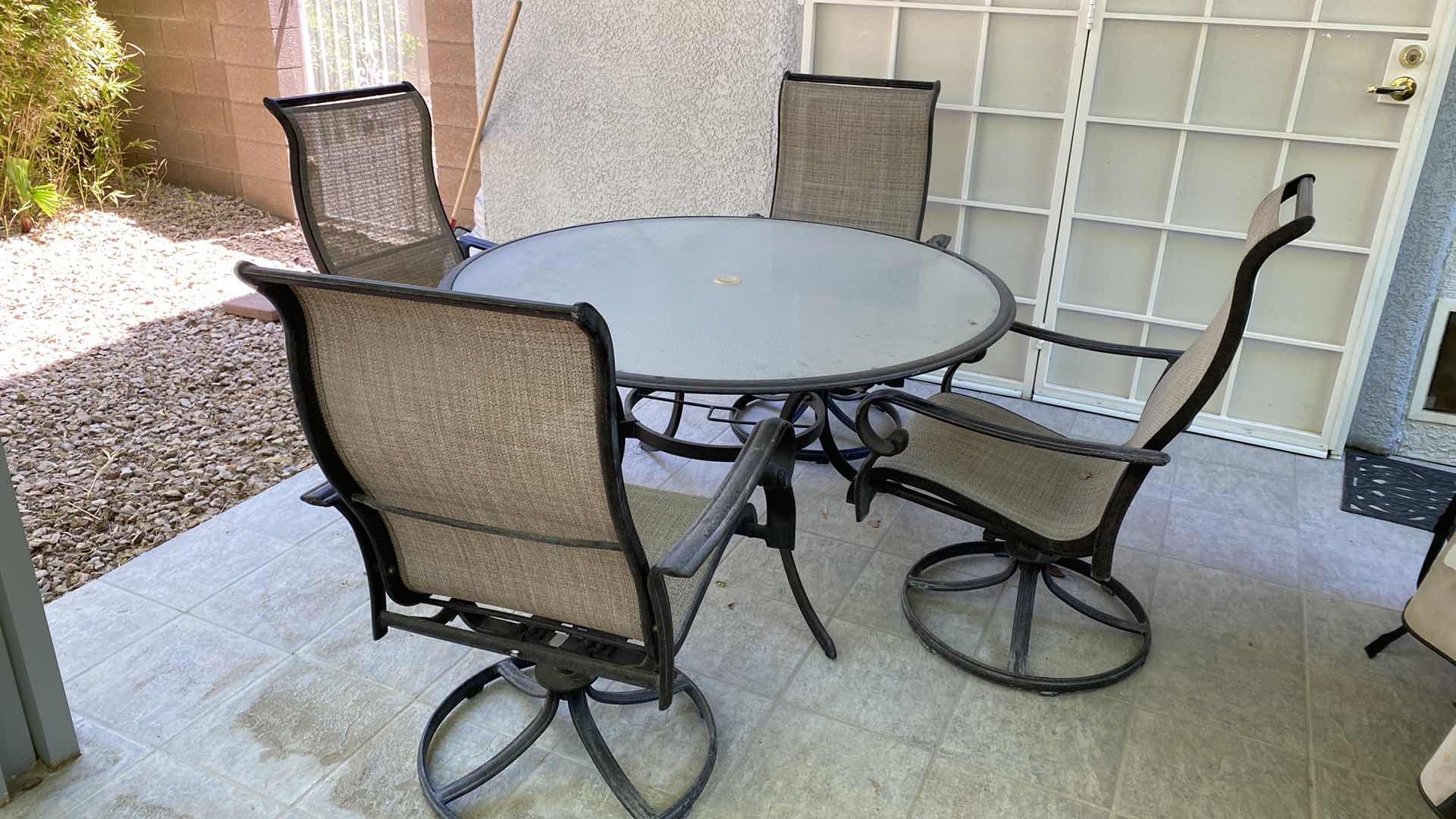 Photo 2 of GLASS AND ALUMINUM PATIO TABLE 54” WITH 4 SWIVEL CHAIRS