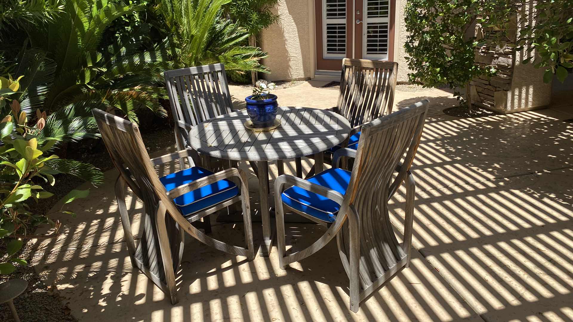 Photo 8 of TEAK WAREHOUSE DINING SET WITH 4 CHAIRS MARINE BLUE WATER REPELLANT AND SUN PROTECTION FABRIC AND POTTED PLANT - TABLE 43” H29” 