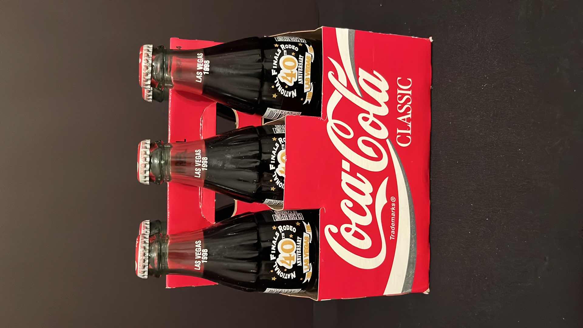 Photo 1 of COCA-COLA COMMEMORATIVE 6-PACK 8 OZ BOTTLES NATIONAL FINALS RODEO 40TH ANNIVERSARY LAS VEGAS UNOPENED, 1998