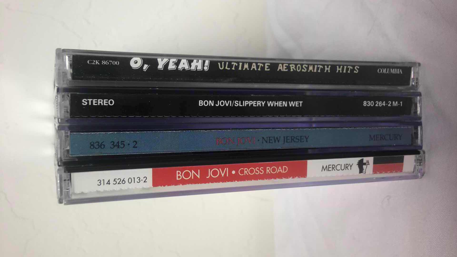 Photo 1 of ASSORTMENT OF BON JOVI AND AEROSMITH ALBUM CDS (4)