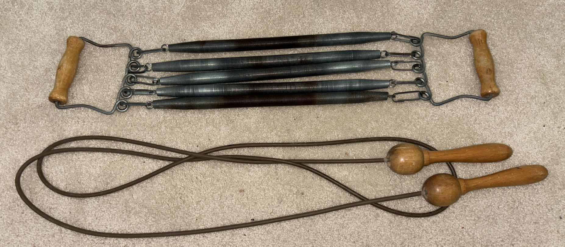 Photo 1 of VINTAGE EXERCISE EQUIPMENT, LEATHER WOODEN HANDLE SKIP JUMP ROPE & 5-SPRING CHEST/ARM PULL W WOOD HANDLES