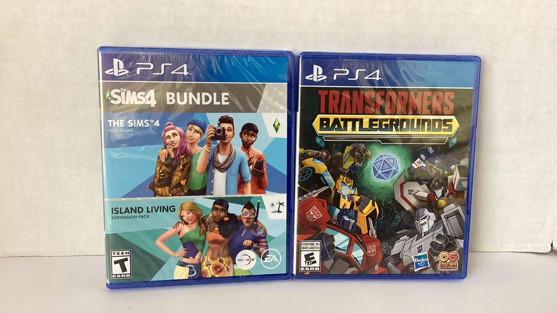 Photo 1 of 2 NEW PS4 GAMES: SIMS 4 BUNDLE AND TRANSFORMERS BATTLEGROUNDS