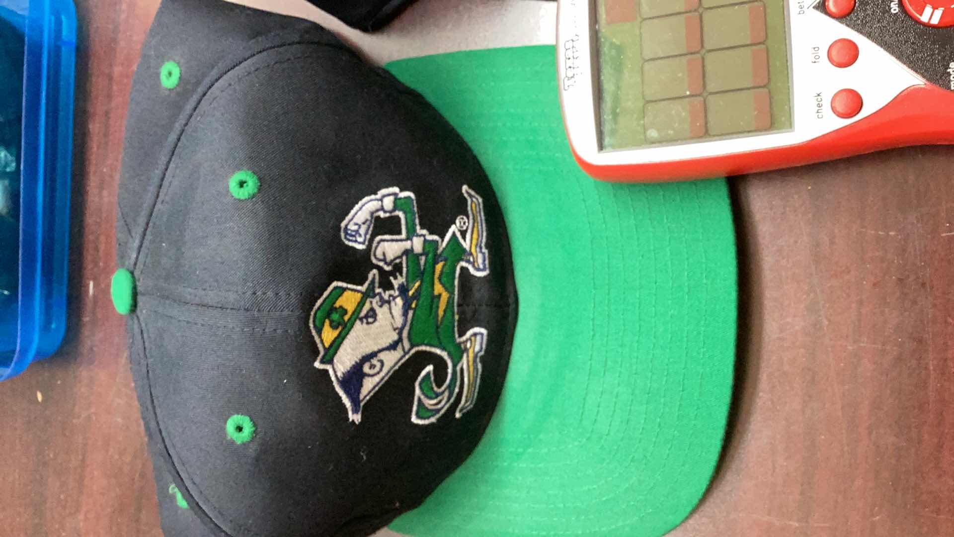 Photo 2 of 2 NOTRE DAMN FOOTBALL CAPS AND HANDHELD GAMES