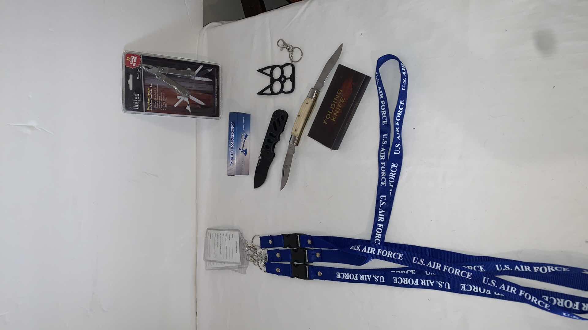 Photo 1 of SET OF U.S. AIR FORCE LANYARDS WITH POCKET TOOLS, TOMAHAWK KNIFE, FOLDING KNIFE, AND CAT EYE MELEE PROTECTION