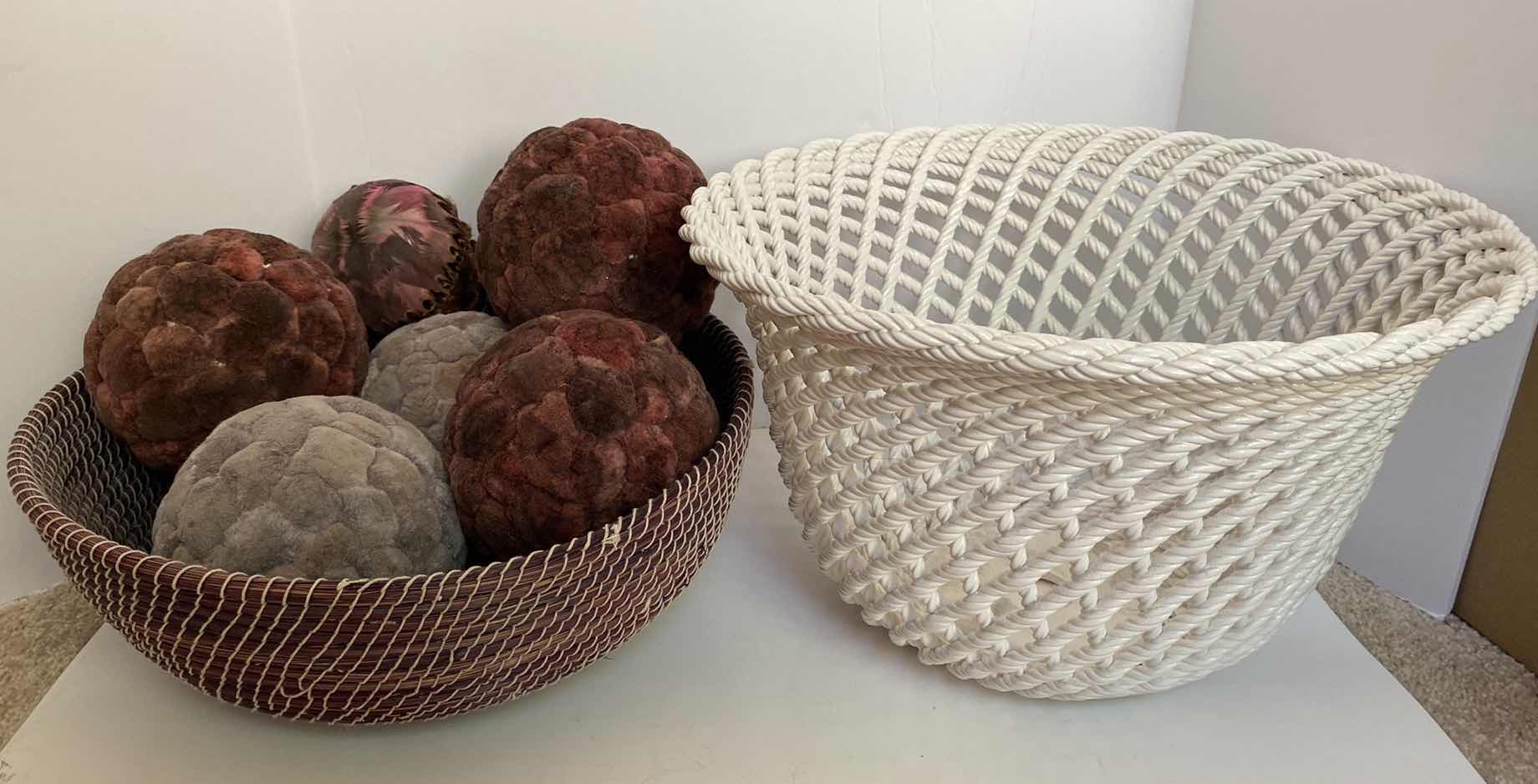 Photo 1 of 1 WOVEN BASKET WITH BALLS AND 1 WHITE METAL BASKET 16” x 9 1/2”